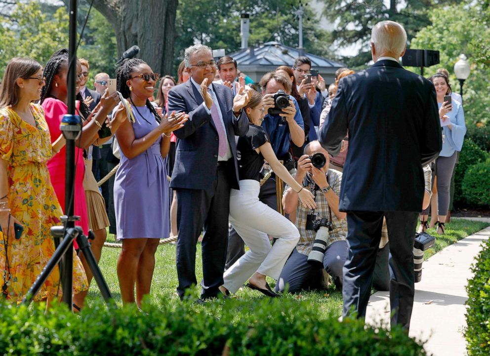 PHOTO: White House staff applaud as President Joe Biden enters the Rose Garden to deliver remarks on COVID-19 at the White House on July 27, 2022 in Washington, DC