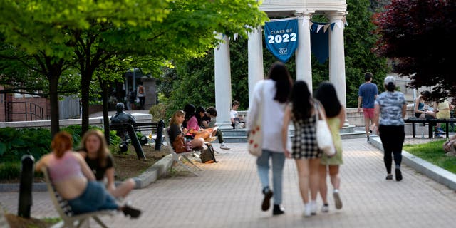 A banner of the Class of 2022 is displayed as students march on the campus of George Washington University in Washington, DC on May 2, 2022. (Photo by Stefani Reynolds/AFP) (Photo by STEFANI REYNOLDS/AFP via Getty Images )