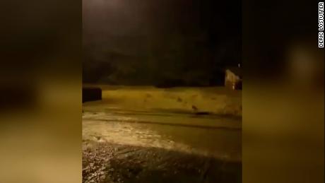 Floodwaters pass a home in the Breathitt County community of Jackson early Thursday.