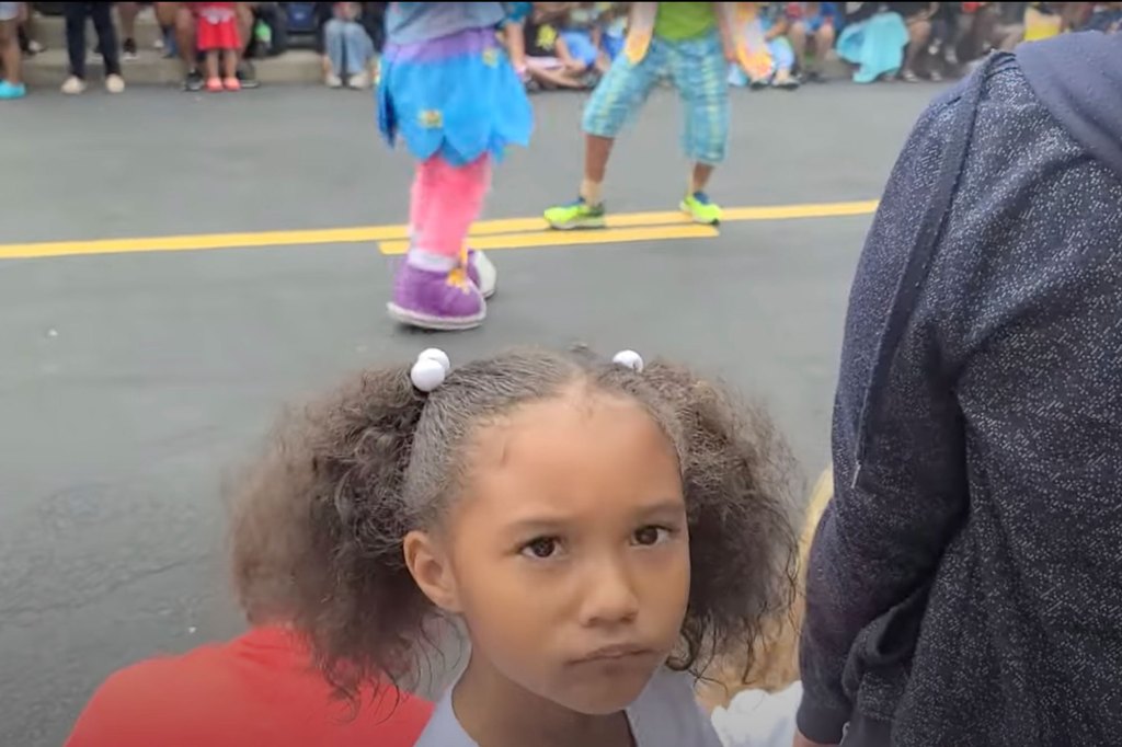 Five-year-old Kennedi Burns looks puzzled after Sesame Characters ignored his handshake.