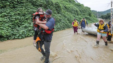 A group of stranded people are rescued from flood waters in Jackson, Kentucky.