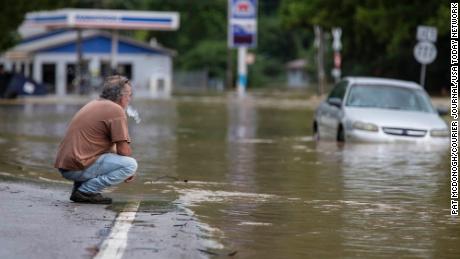 Van Jackson checks in on his dog, Jack, who was stranded in a church by floodwaters along Right Beaver Creek in Garrett, Ky., on Thursday.