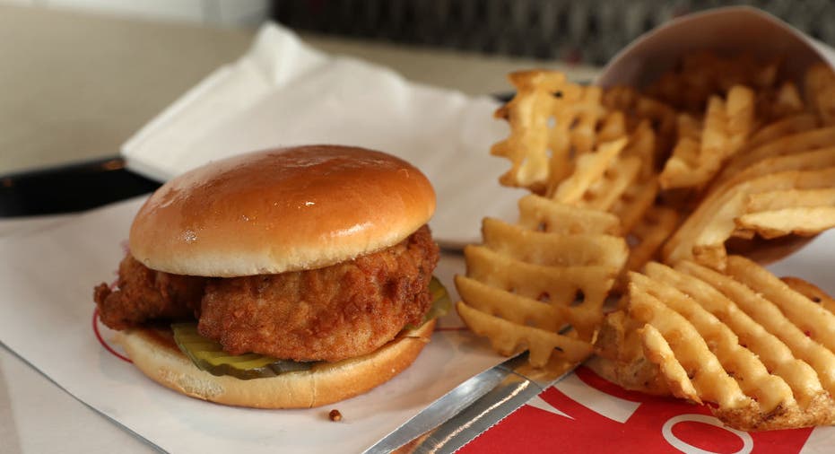 A chicken sandwich with waffle fries