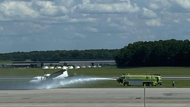 Crews spray the area around the aircraft.  Image courtesy of Simon Palmore.