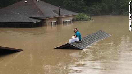 A 17-year-old girl swam out of her flooded house with her dog and waited hours on a rooftop for rescue