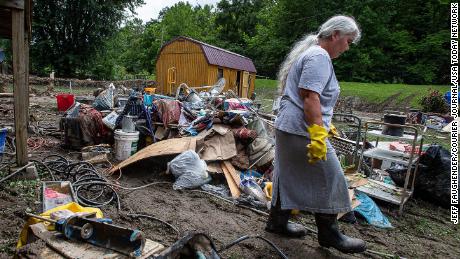 Libby Duty, 64, of Jenkins, Kentucky, walked through her backyard while cleaning her basement on Saturday after historic rains flooded many areas of eastern Kentucky.