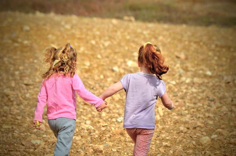 This shows two young girls playing