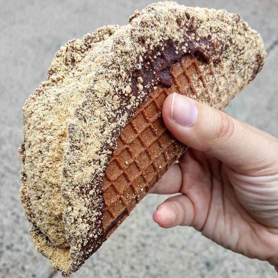 Close-up photo of a hand holding a choco taco made by an independent ice cream shop