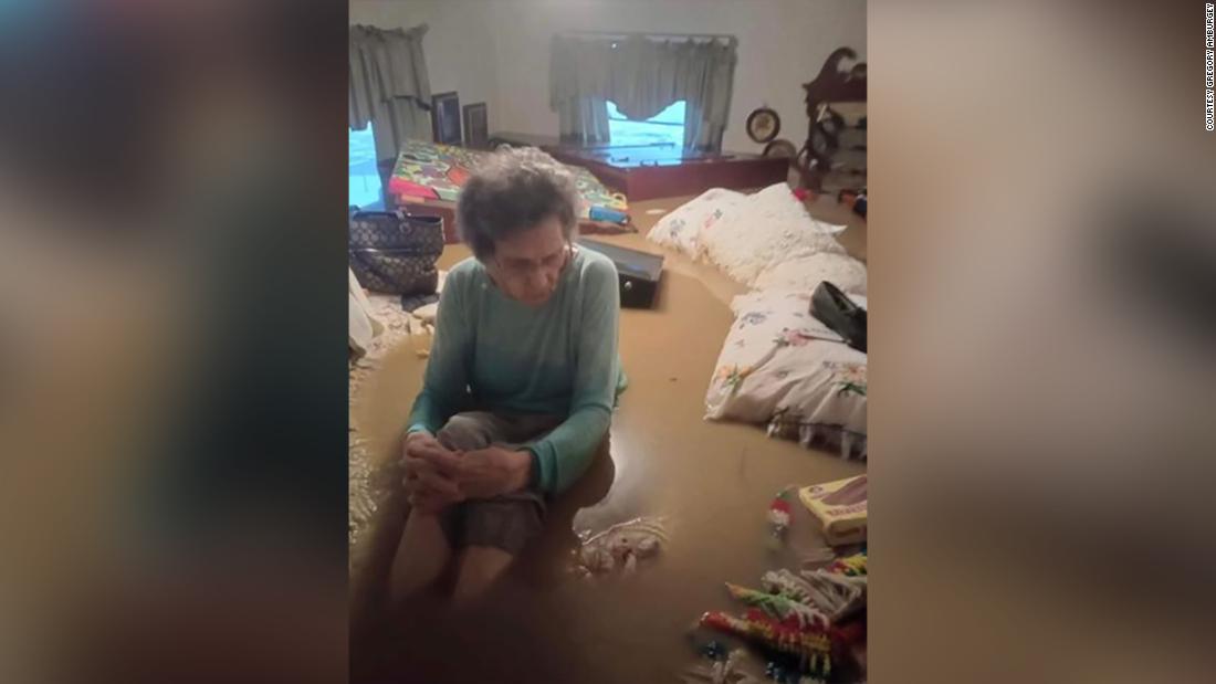 Unidentified man saves his grandmother and loved ones as their home is nearly engulfed in floods

